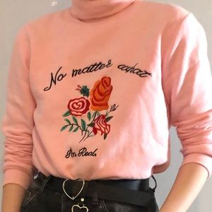 “No matter what, I’m real” Pink turtle neck